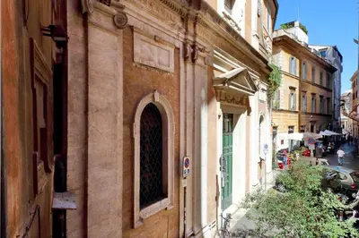 an old building with a window on a city street at Parione Charme - My Extra Home in Rome