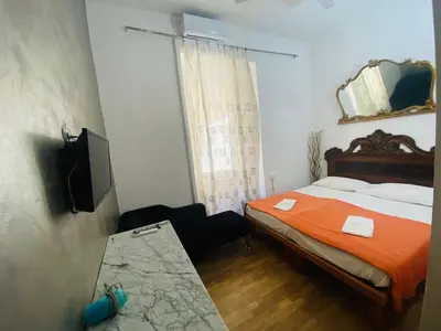 a bedroom with a bed and a table in it at Roman Place in Rome