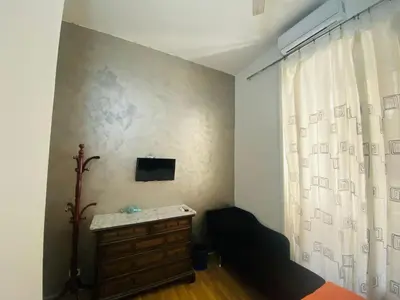 a bedroom with a bed and a dresser and a window at Roman Place in Rome