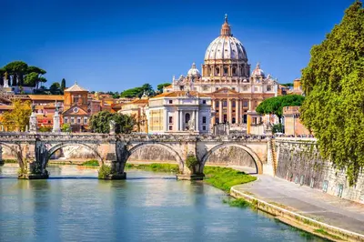 a bridge over a river in front of a city at Lilli Home Holidays in Rome