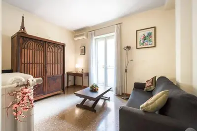 a living room with a couch and a table at Magnifico Cozy Apartment 400m da metroB in Rome