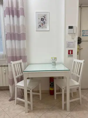 a white table with two chairs and a glass top at Casa Vacanze Marzia in Rome
