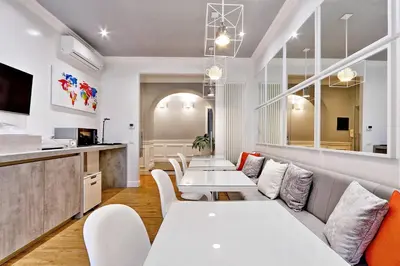 a restaurant with white tables and white chairs at Vatican Chic B&B in Rome