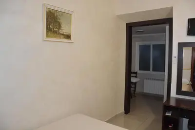 a room with a mirror and a picture on the wall at Roma Carina in Rome