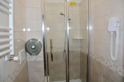 a shower with a glass door in a bathroom at Roma Carina in Rome