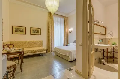 a hotel room with a bed and a sink at Rome Charming Suites in Rome
