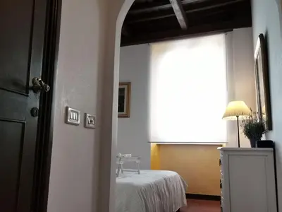 a room with a bed and a window and a door at House Maximo near Vatican in Rome