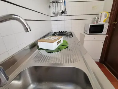 a kitchen counter with a sink and a box on it at House Maximo near Vatican in Rome