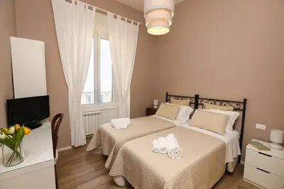 a bedroom with two beds with towels on them at Vatican Garden Rooms in Rome