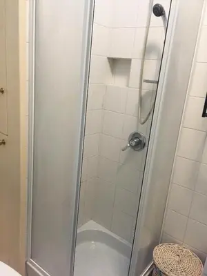 a shower with a glass door in a bathroom at Trastevere four seasons Valadier in Rome