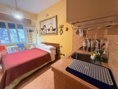 a kitchen with a sink and a bed in a room at Suites Oliveri Viale Marconi in Rome
