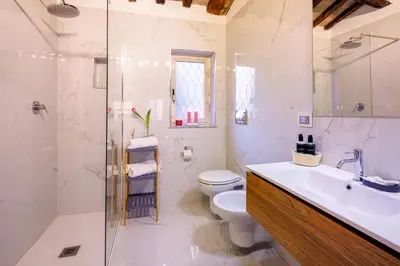 a bathroom with a toilet and a sink and a shower at Romanticasa Trastevere in Rome