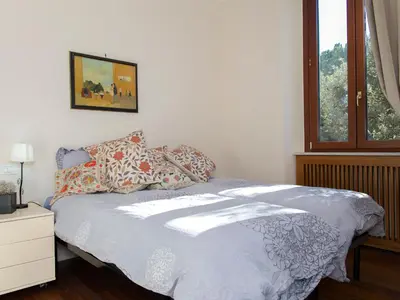 a bedroom with a bed with pillows and a window at The Apartments - Vatican in Rome