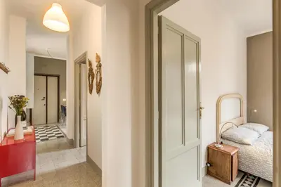 a bedroom with a bed and a door leading to a hallway at Monti Coliseum Apartment in Rome