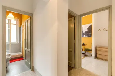 a hallway with a bathroom with a toilet and a sink at Monti Coliseum Apartment in Rome