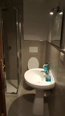 a bathroom with a toilet and a sink and a shower at Wonderful Time Rome in Rome