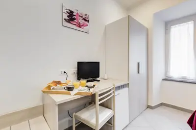 a room with a desk with a computer and a chair at Wonderful Time Rome in Rome