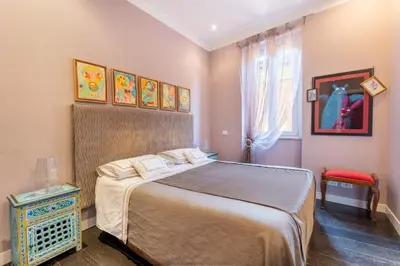 a bedroom with a large bed and a window at Atmosphera Trastevere, Glamour apartment in the center in Rome