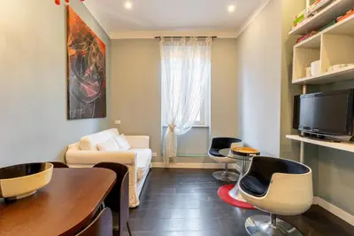 a living room with a couch and a table and chairs at Atmosphera Trastevere, Glamour apartment in the center in Rome