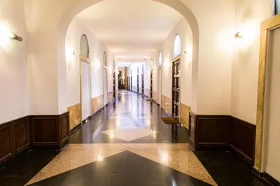 an empty hallway of a building with an archway at Corso Experience in Rome