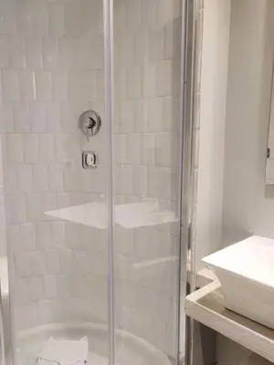 a shower with a glass door next to a sink at Corso Experience in Rome