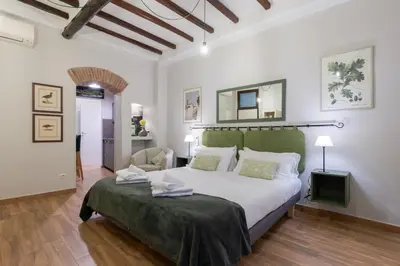 a bedroom with a large bed with a green headboard at Rome as you feel - Piazza dei Satiri apartments in Rome