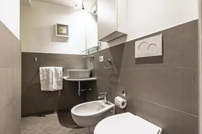 a bathroom with a toilet and a sink at Rome as you feel - Piazza dei Satiri apartments in Rome