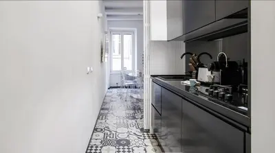 a kitchen with a black counter and a tile floor at Navona Hi-Tech Apartment in Rome