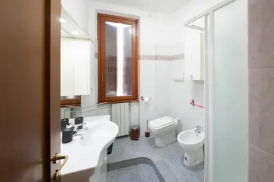 a bathroom with a white sink and a toilet at ROMA18 in Rome