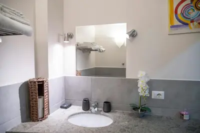 a bathroom with a sink and a mirror at ROMA18 in Rome
