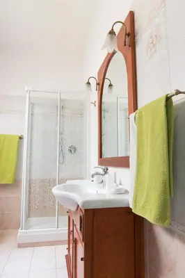 a bathroom with a sink and a mirror and a shower at Floreo Guest House in Rome
