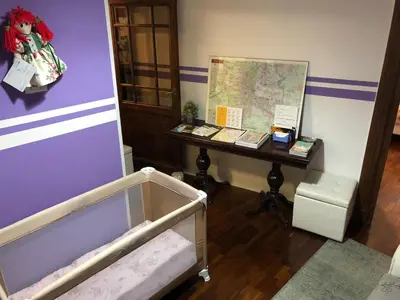 a room with a desk with a map and a table with a bed at Catherine's Home in Rome