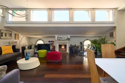a living room with a couch and a fire place at La Mia Casa in Campo di Fiori in Rome