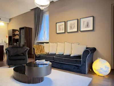 a living room with a couch and a table at The Babuino - Luxury serviced apartment in Rome