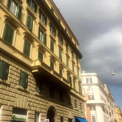 a building with a balcony on the side of it at Roman Suite Guest House in Rome