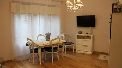 a dining room with a table and chairs and a television at La Cupola Suite in Rome