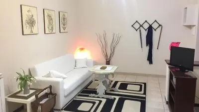a living room with a white couch and a table at Lorenzo Magnifico Apartment in Rome