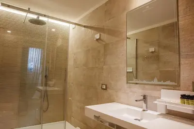 a bathroom with a sink and a shower with a mirror at My Spanishsteps in Rome