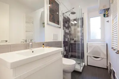 a white bathroom with a sink and a toilet at Saint Peter Basilica 200m- 2BR -2BA -Sleeps 6 in Rome
