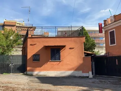 an orange building with a balcony on top of it at Villino Marcella in Rome