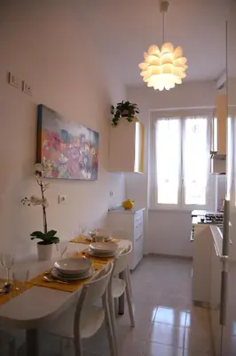 a kitchen with a table with plates on it at FHR-Appartamento a San Giovanni in Rome