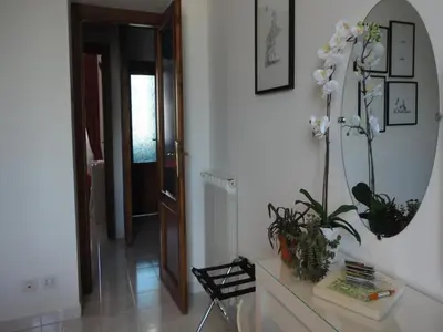 a room with a mirror and a table with plants at FHR-Appartamento a San Giovanni in Rome