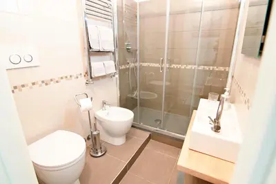 a bathroom with a toilet and a shower and a sink at Mio House Vatican in Rome