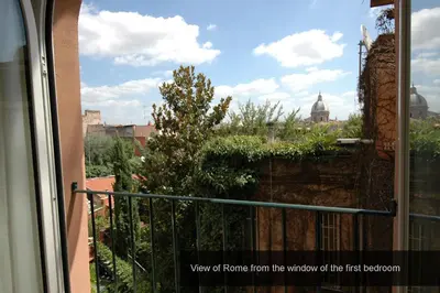 a view of a city from the window of a balcony at HISTORICAL CENTER ROME NAVONA AC 2 ROOMS HOLY DOOR VATICAN 5 MINUTES ON WALk in Rome