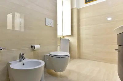 a bathroom with a toilet and a sink at Elite Rome Apartments in Rome