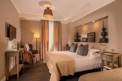 a hotel room with a bed and a chair at The B Place in Rome
