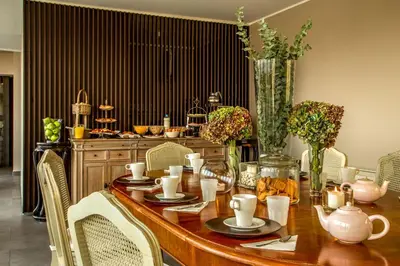 a dining room table with chairs and a table with vases at The B Place in Rome