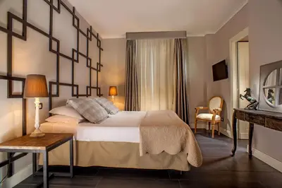a hotel room with a large bed and a table at The B Place in Rome