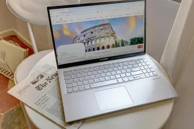 a laptop computer sitting on top of a table at Appartamento Santi Quattro - Colosseo in Rome