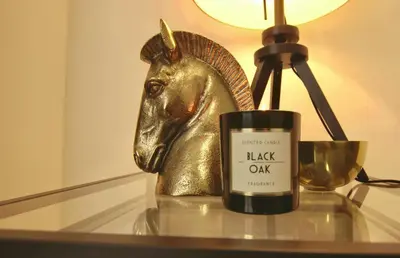 a candle on a table next to a brass horse statue at Domus in Laterano in Rome